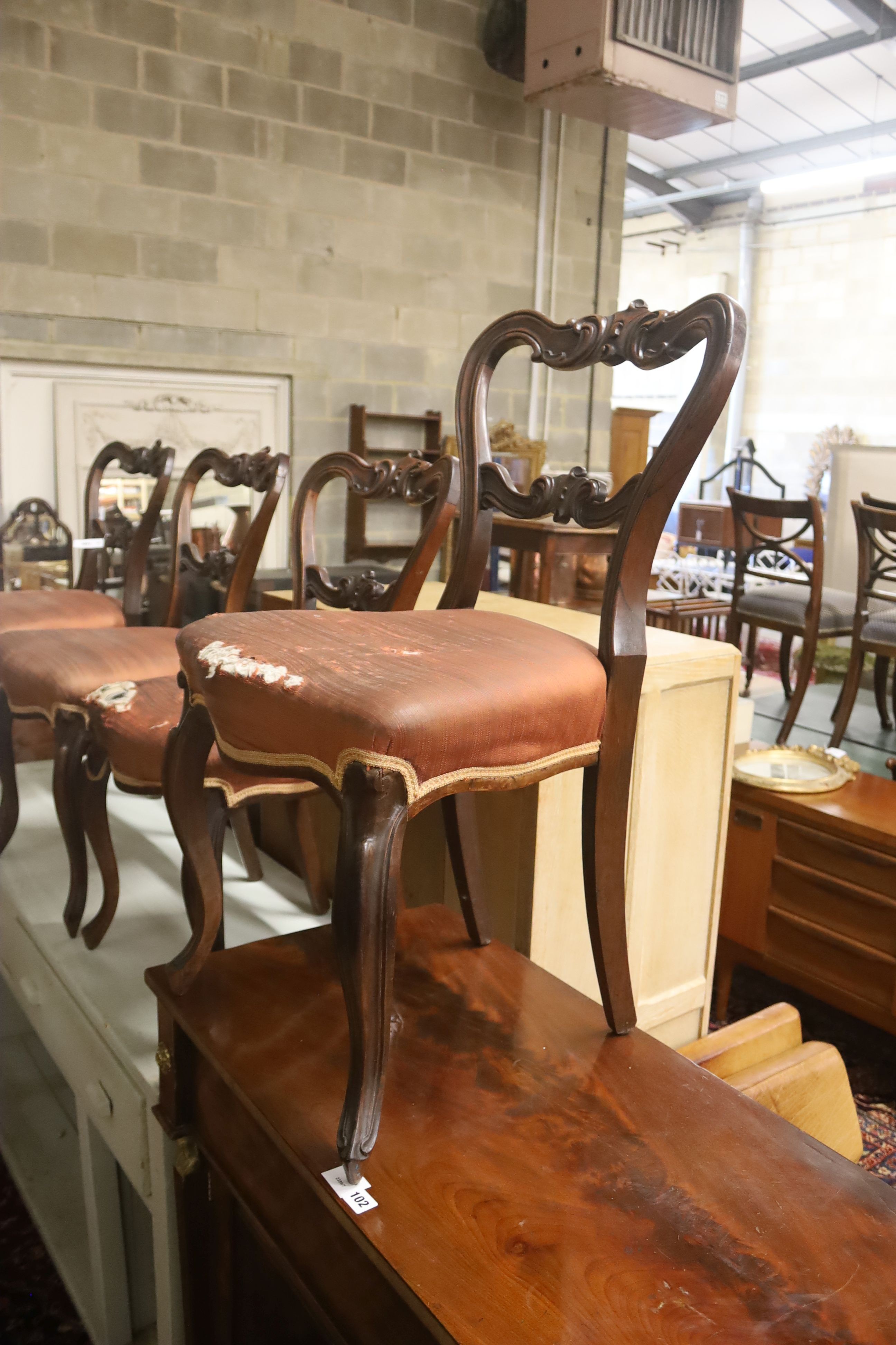 A set of six Victorian carved rosewood balloon back dining chairs